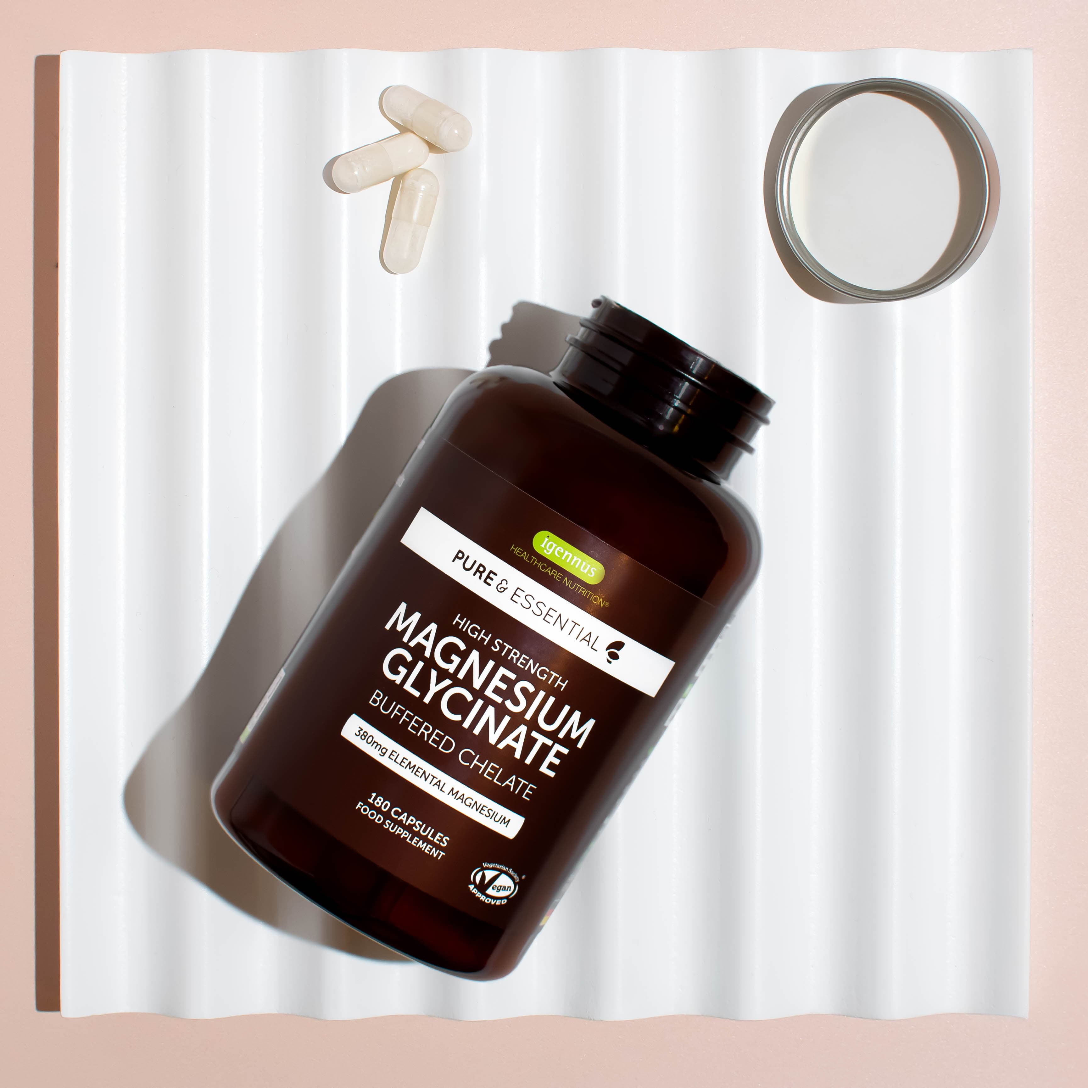 Magnesium supplement bottle suspended beside a ribbon and circular prop