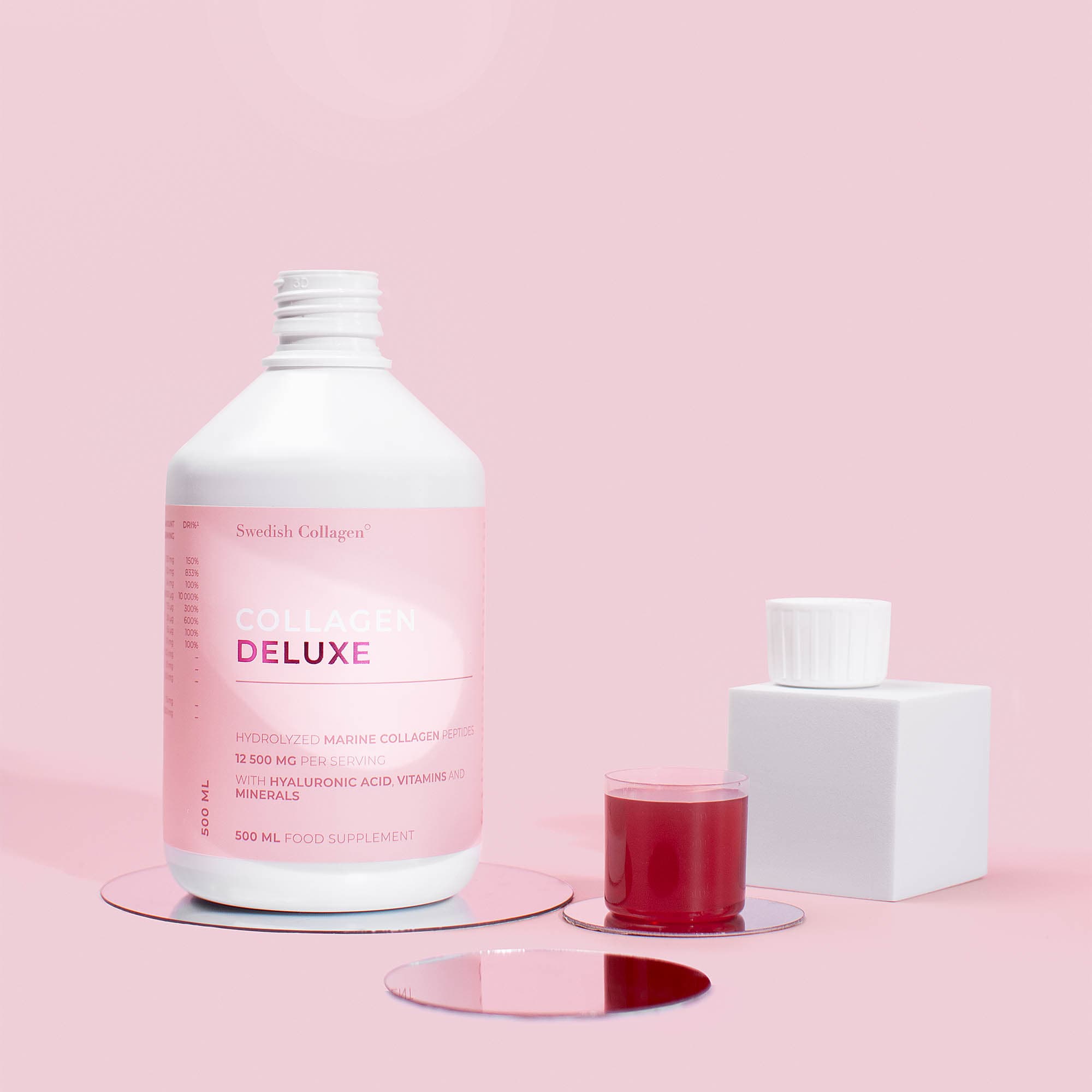 Manicure product bottles arranged on a pink studio set