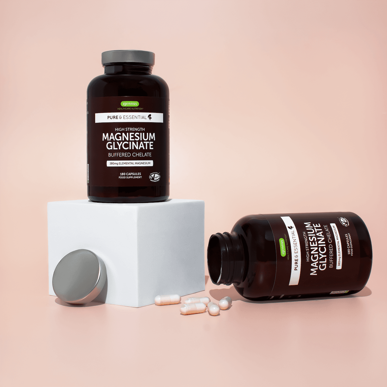 Magnesium supplement bottles and tablets styled on white plinths