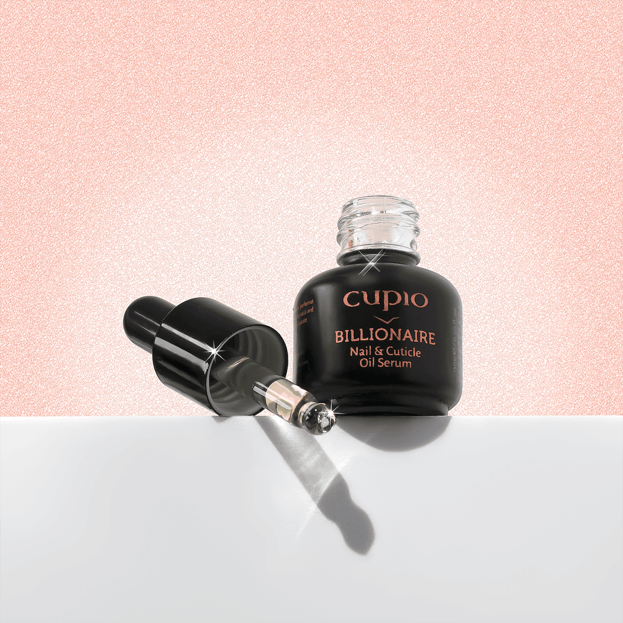 Cupio cuticle oil and pipette on a blush pink product photography set