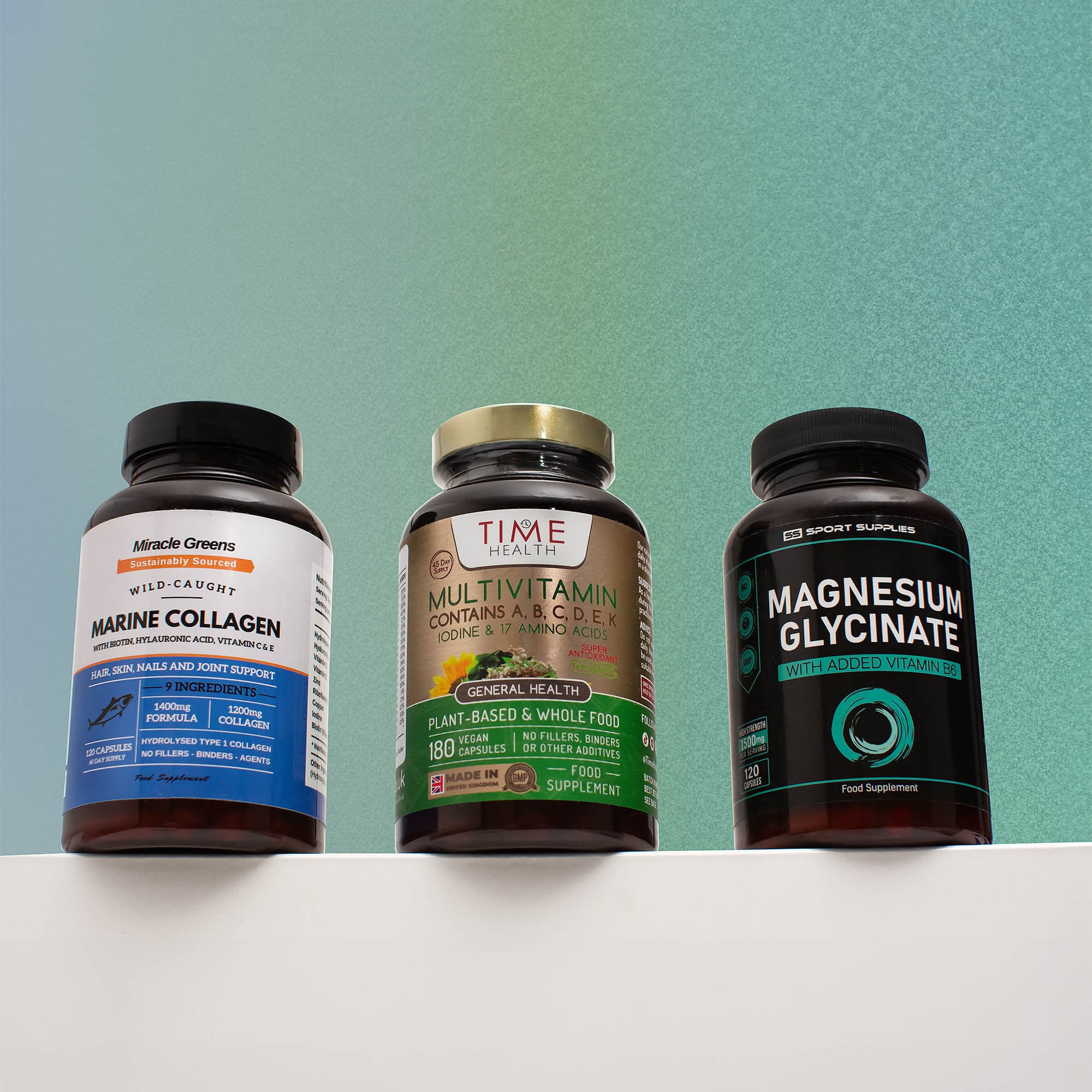 Three supplement bottles arranged against a green textured backdrop
