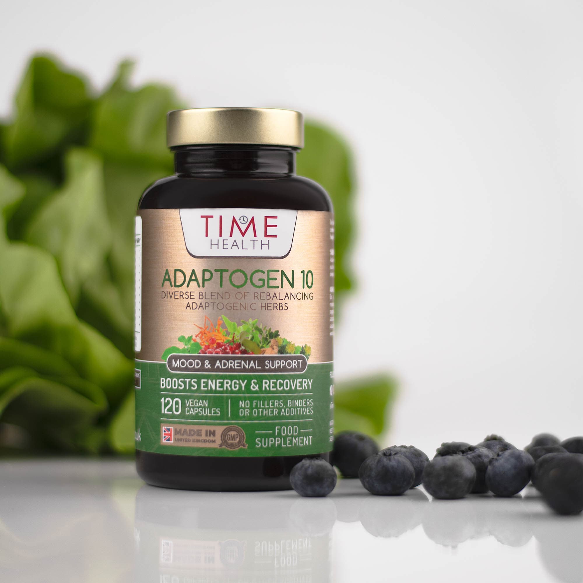 Adaptogen supplement bottle with fresh blueberries and leaves