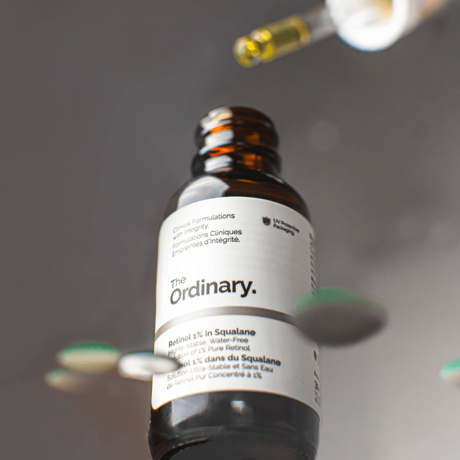The Ordinary serum pipette suspended above an amber bottle