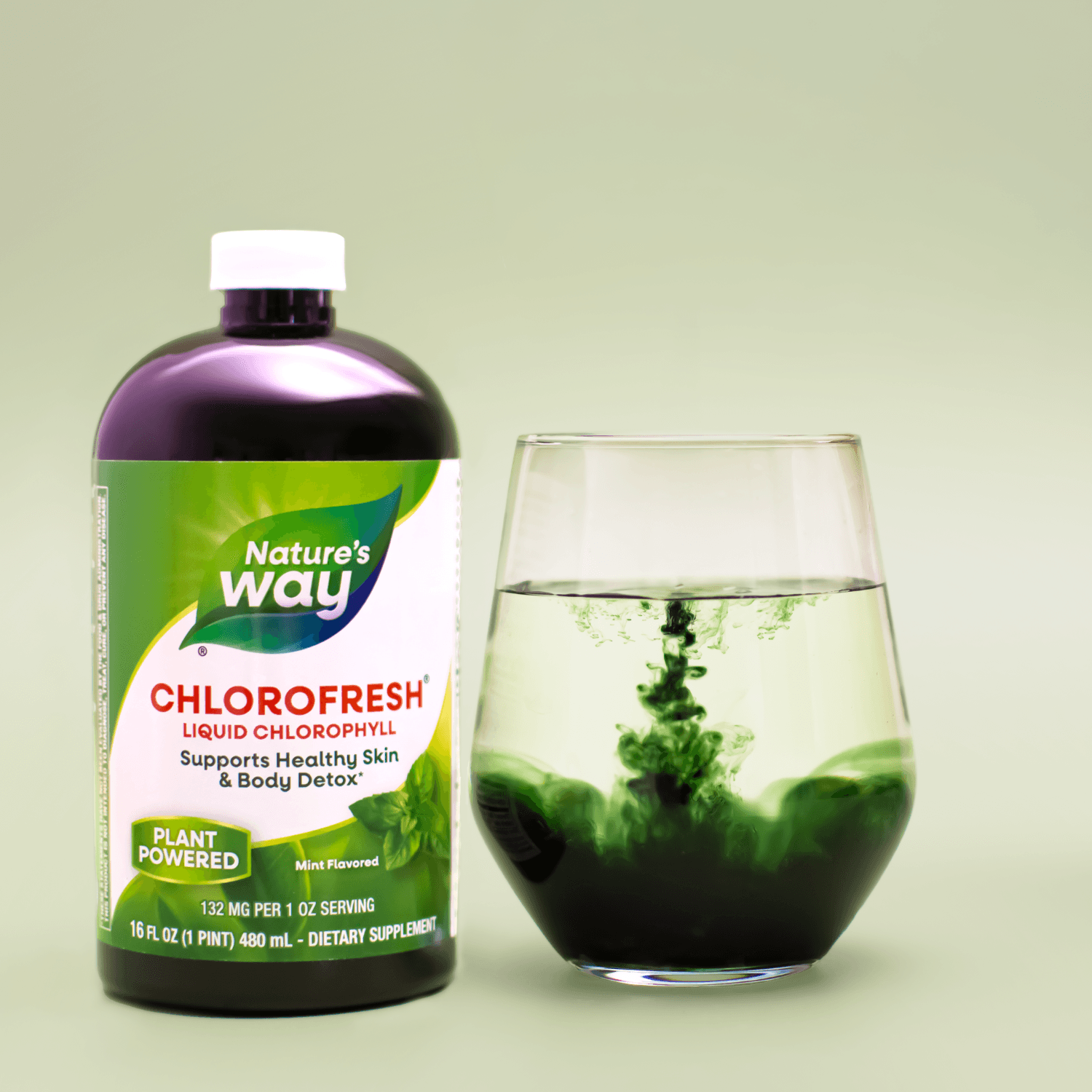 Chlorofresh bottle and a glass of green liquid with ice on a green set