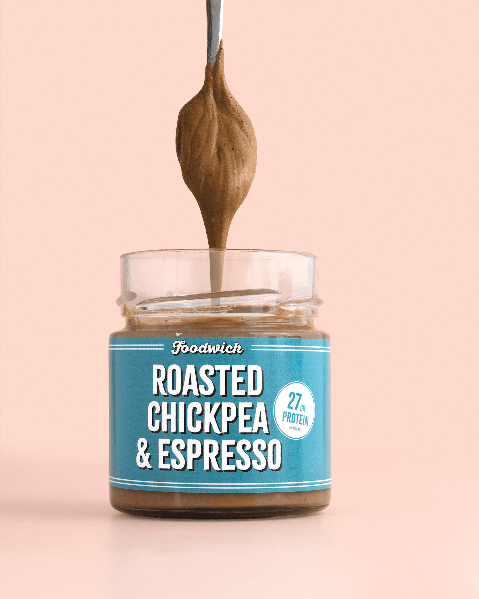 Roasted chickpea and espresso spread on a spoon above a jar