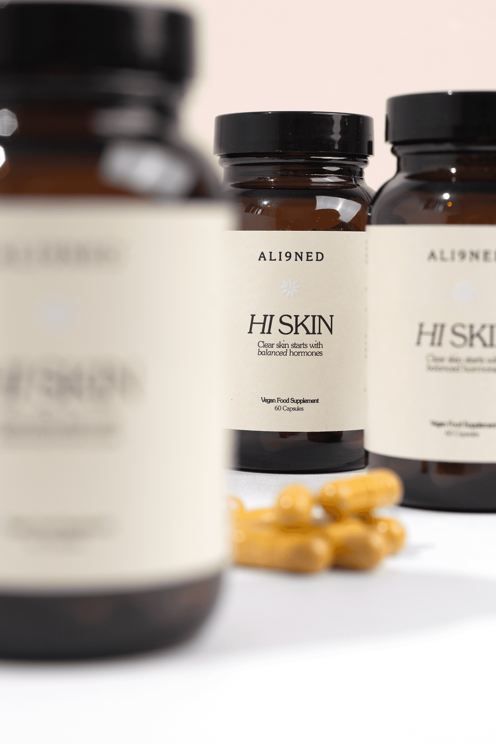 Supplement bottles and golden capsules photographed with shallow depth of field